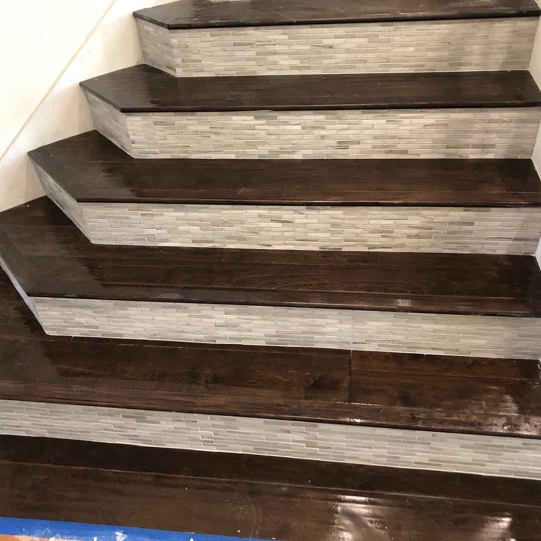 A close up of a set of wooden stairs in a house.