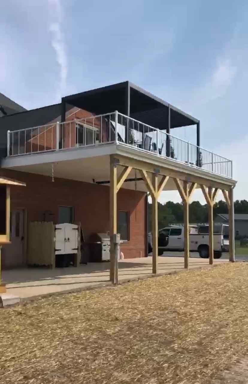 A house with a large deck on top of it