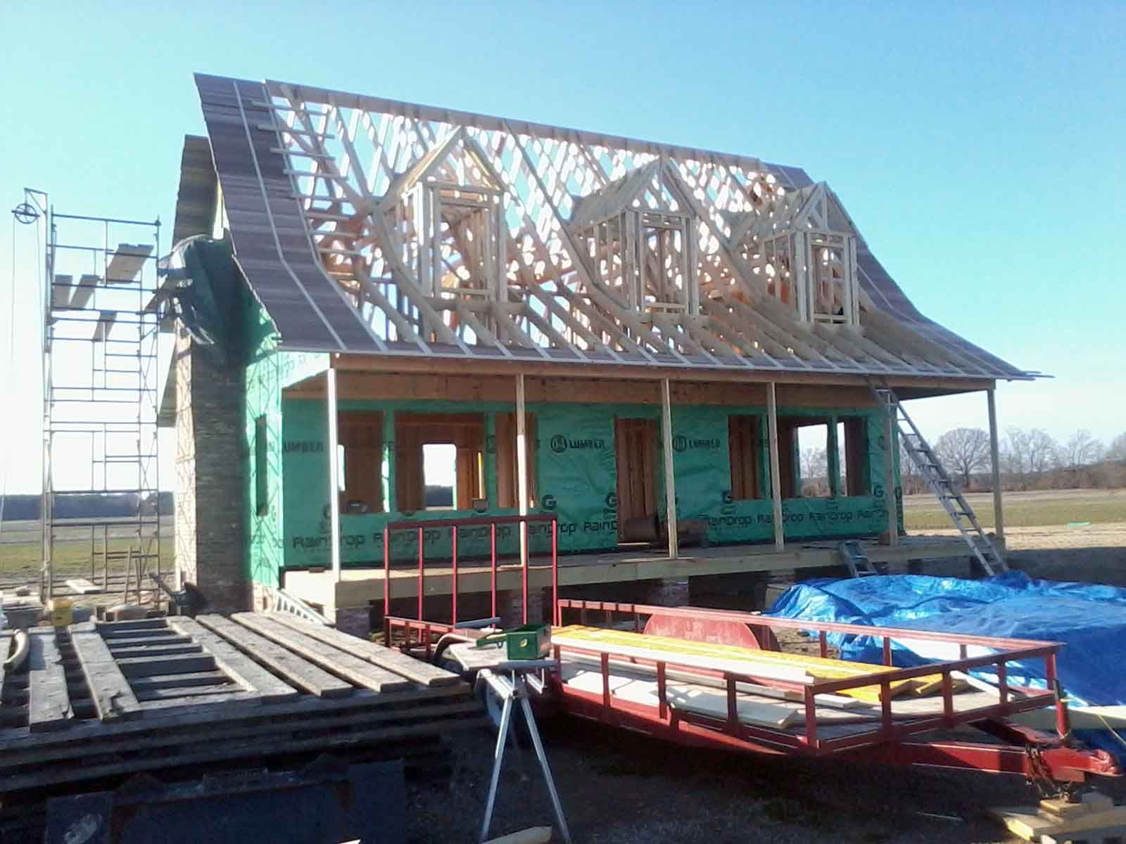 A house that is being built with a green roof