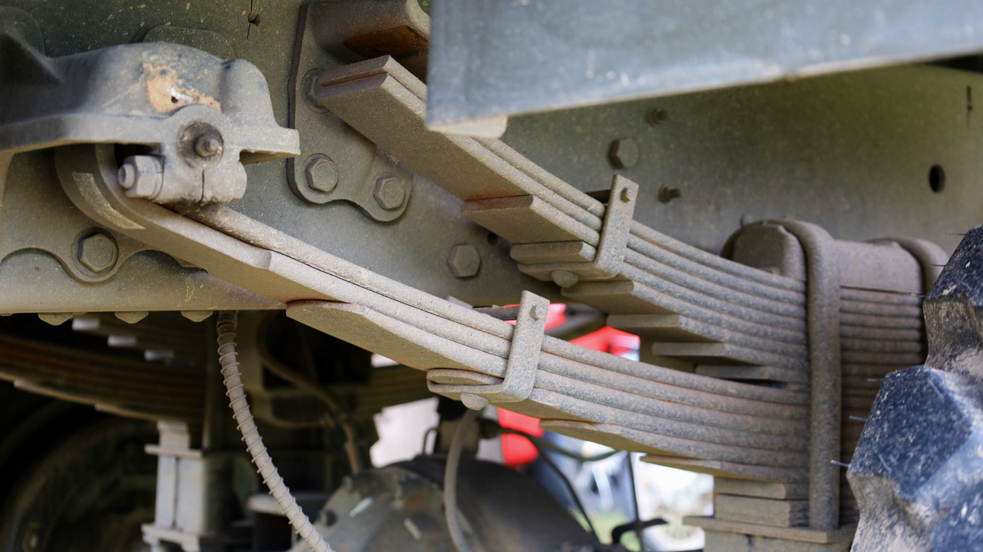 Leaf springs on the undercarriage of a vehicle.