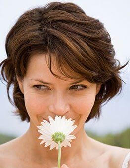 Woman with flower - gynecology clinic in Ocala, FL