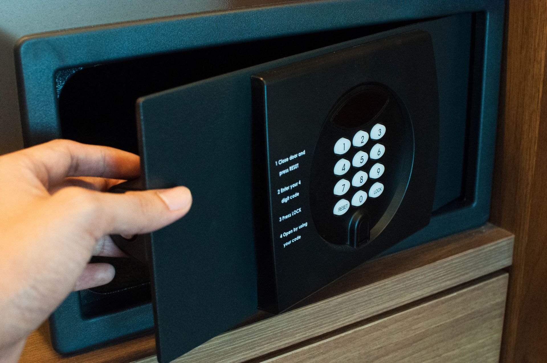 A man is opening a safe as part of safe moving to ensure secure transport during a relocation.