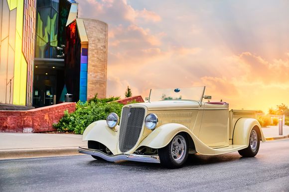 1935 ford Ute in yellow parked in front of sunrise in Leawood, Kansas