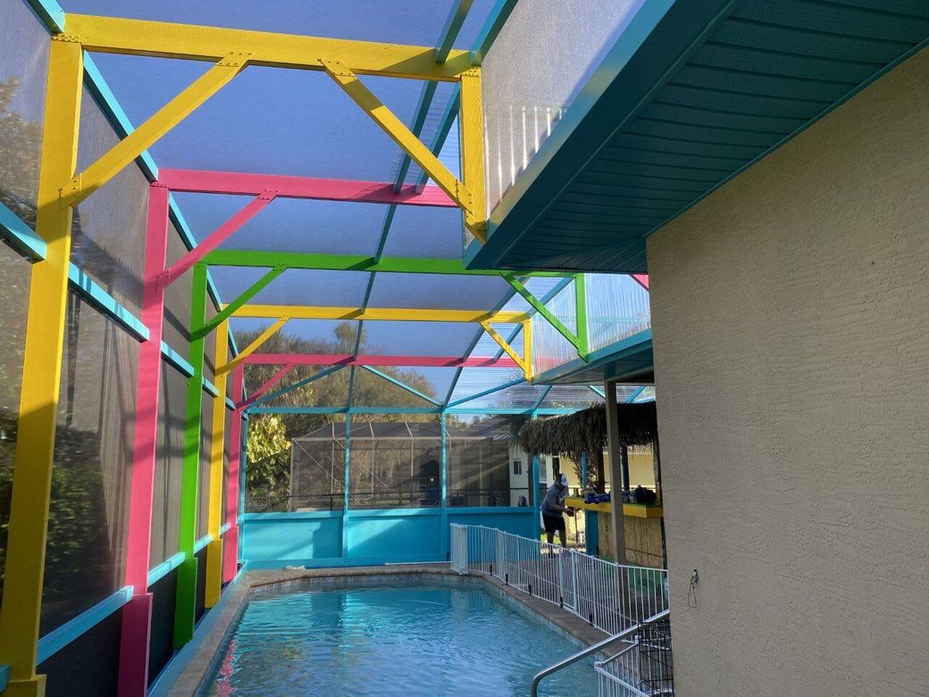 A swimming pool with a colorful canopy over it