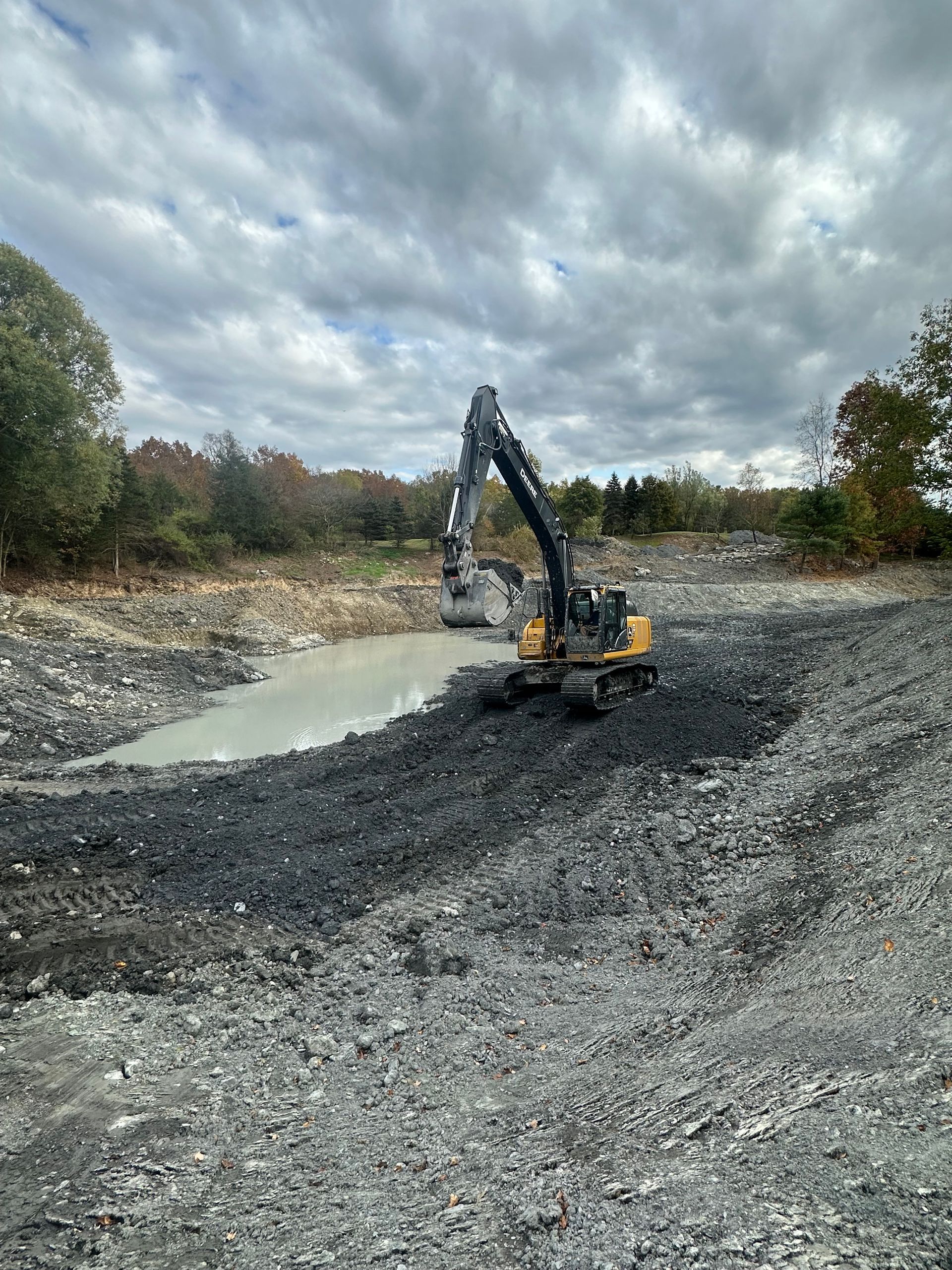 A large excavator is working on a large body of water.