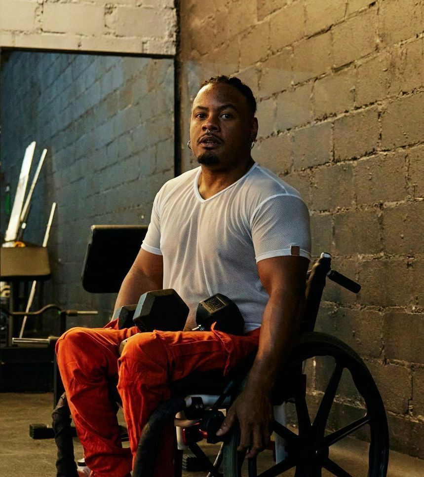 A man with a beard is running on a pier near the water.