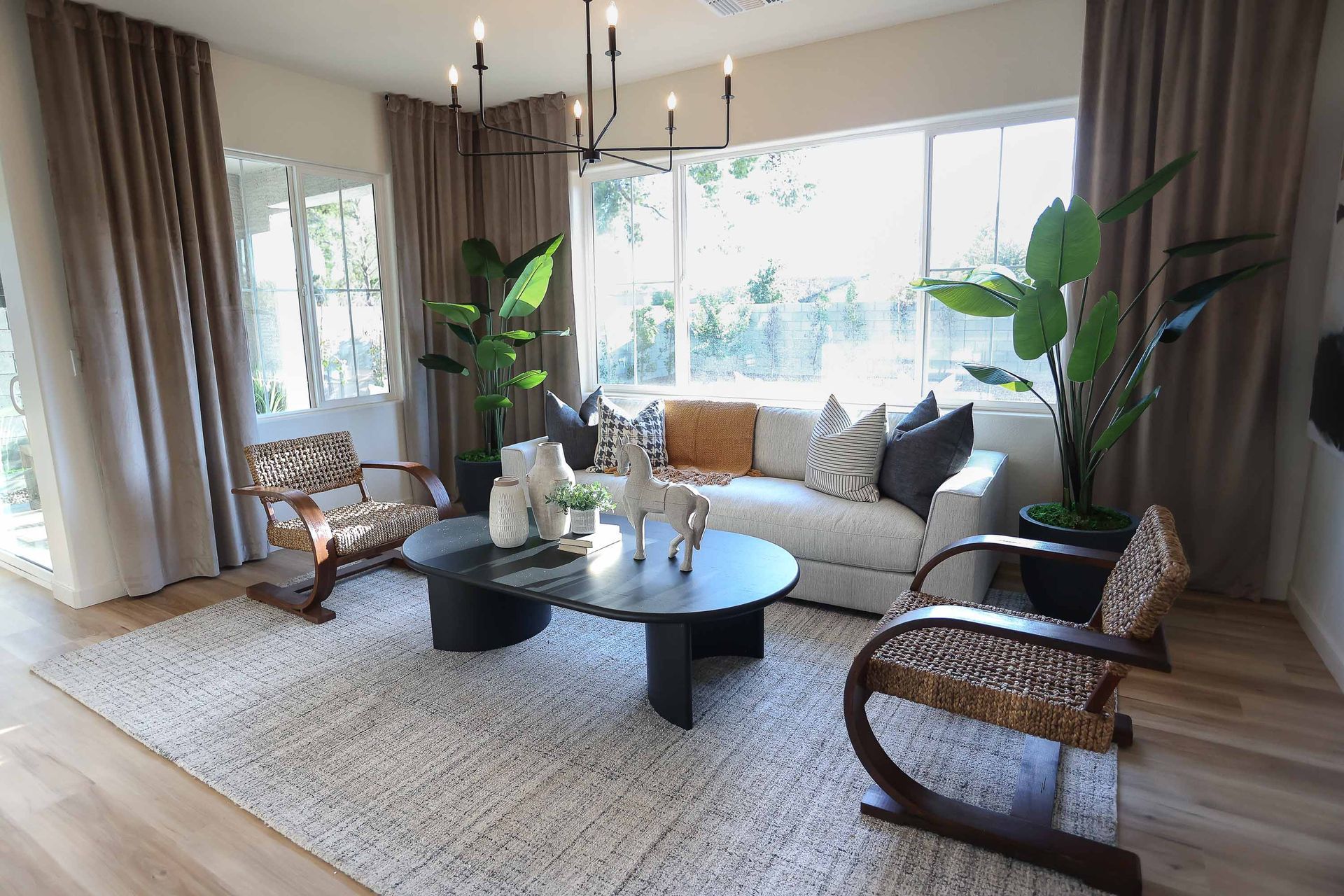 a living room with a sectional couch and a ceiling fan .