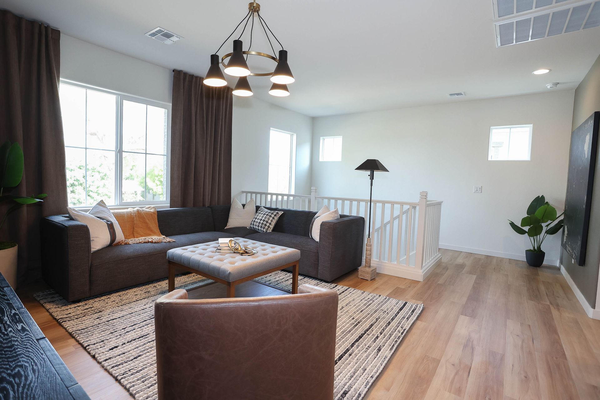 a living room with a couch , dining table , chairs and a kitchen .