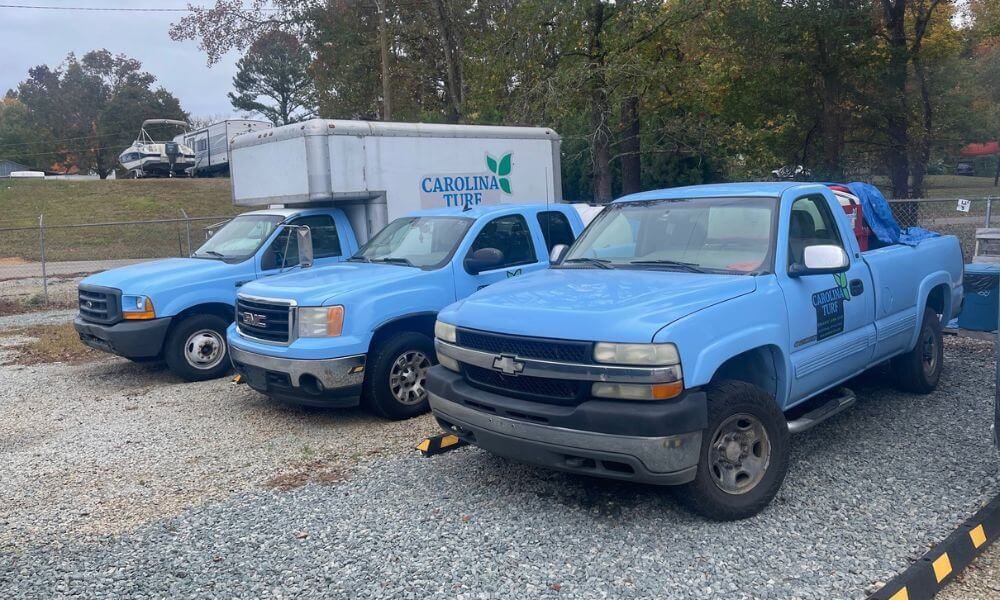 3 Carolina Turf light blue trucks parked at our dispatch location in Cary, NC.