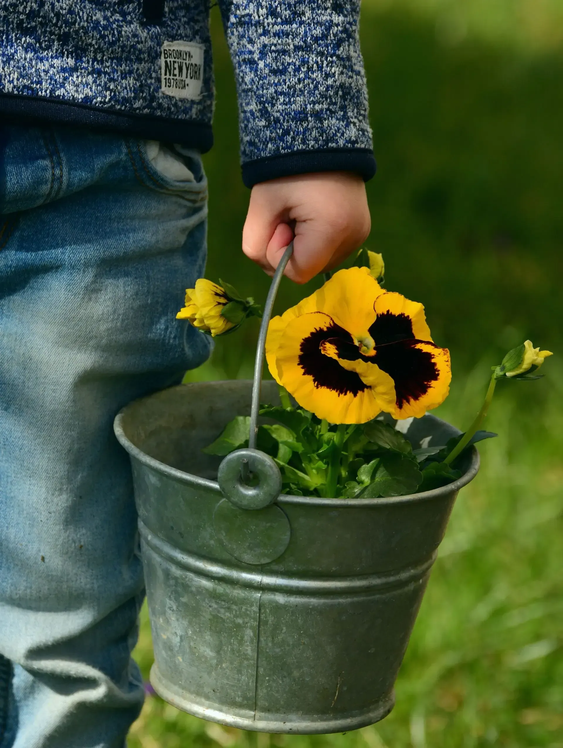 A little boy carrying flowers