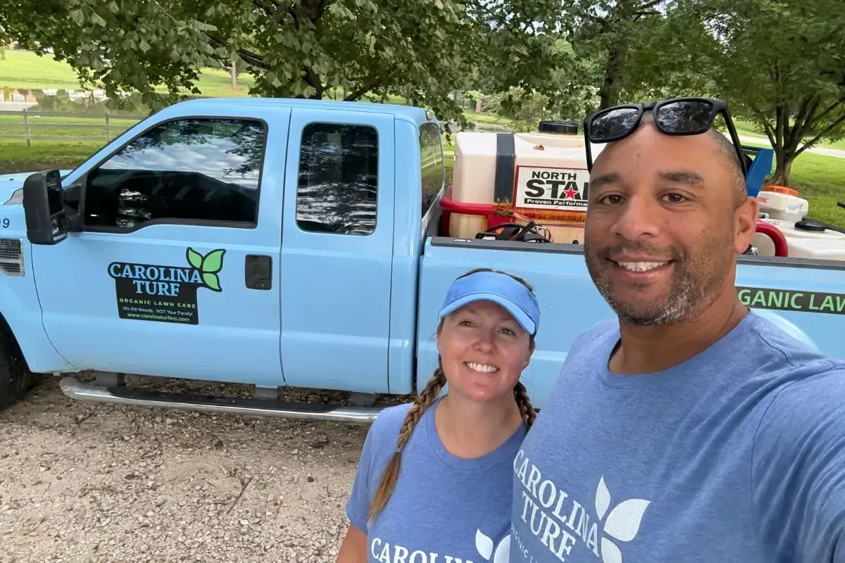 Houston and Hanna Hinson in front of a Carolina Turf truck