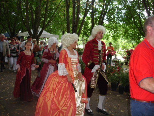 Eine Gruppe von Menschen in historischen Kostümen geht durch einen Park
