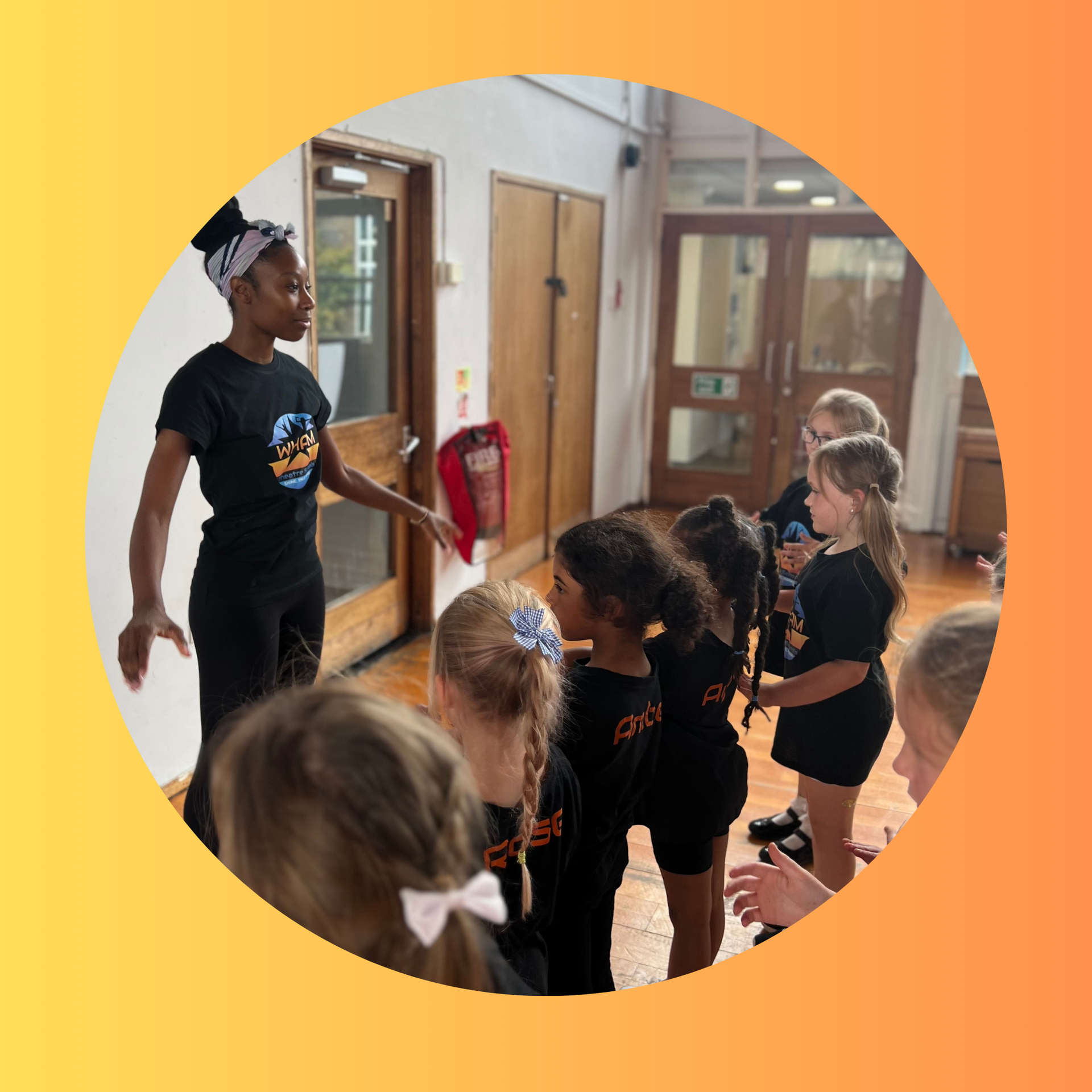 A woman is standing in front of a group of young girls