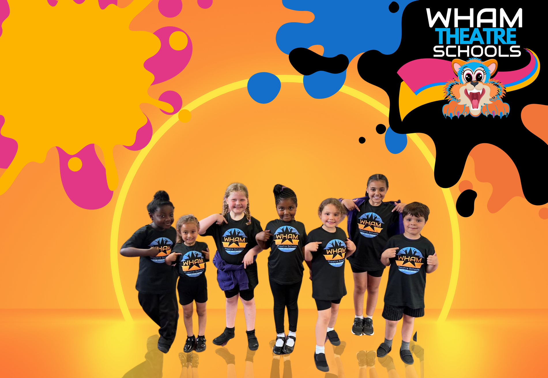 A group of children are standing next to each other in front of an orange background.