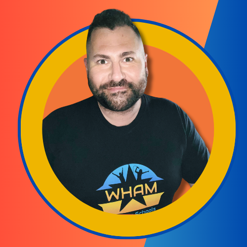 A man with a beard is wearing a wham t-shirt