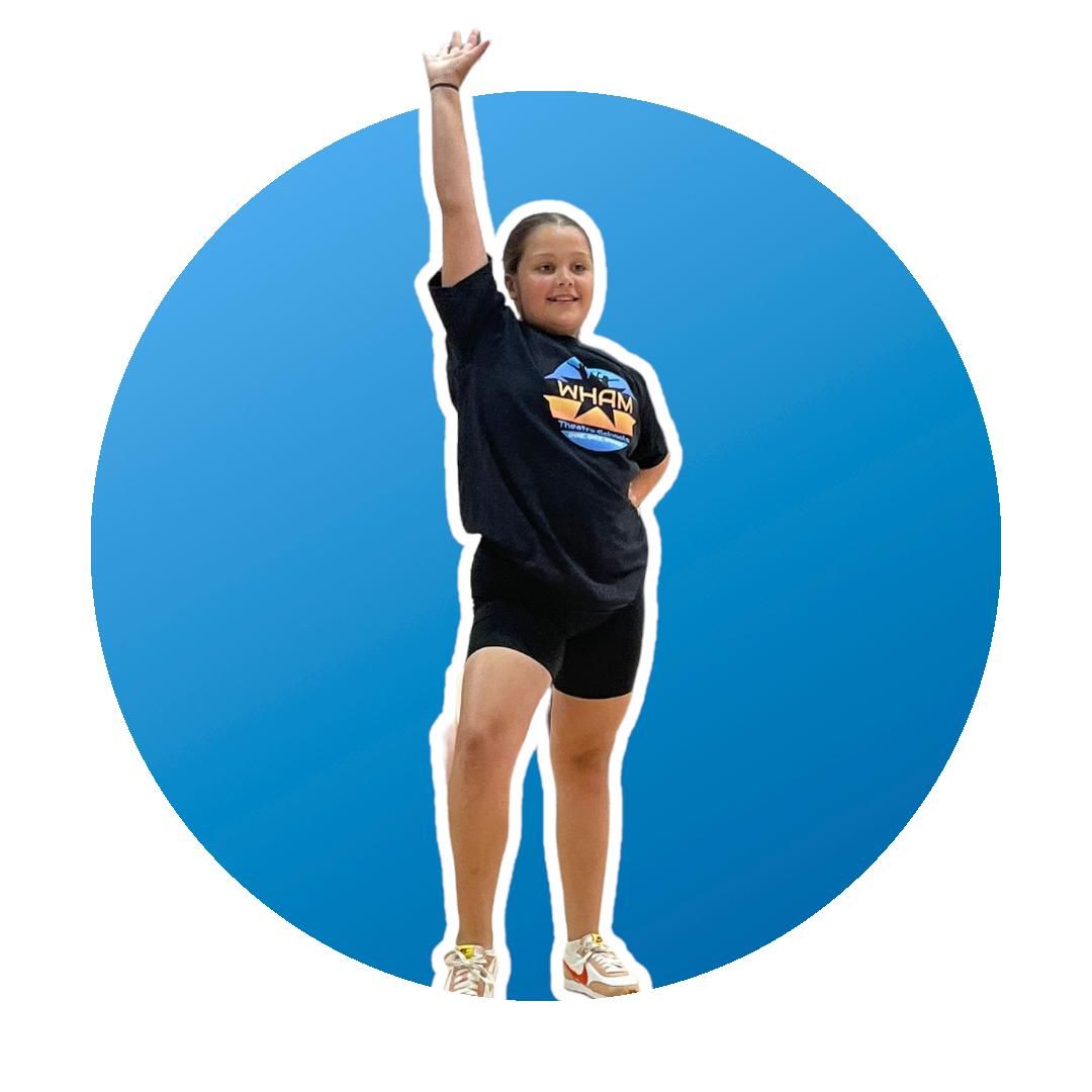 A girl in a black shirt is raising her hand in the air.