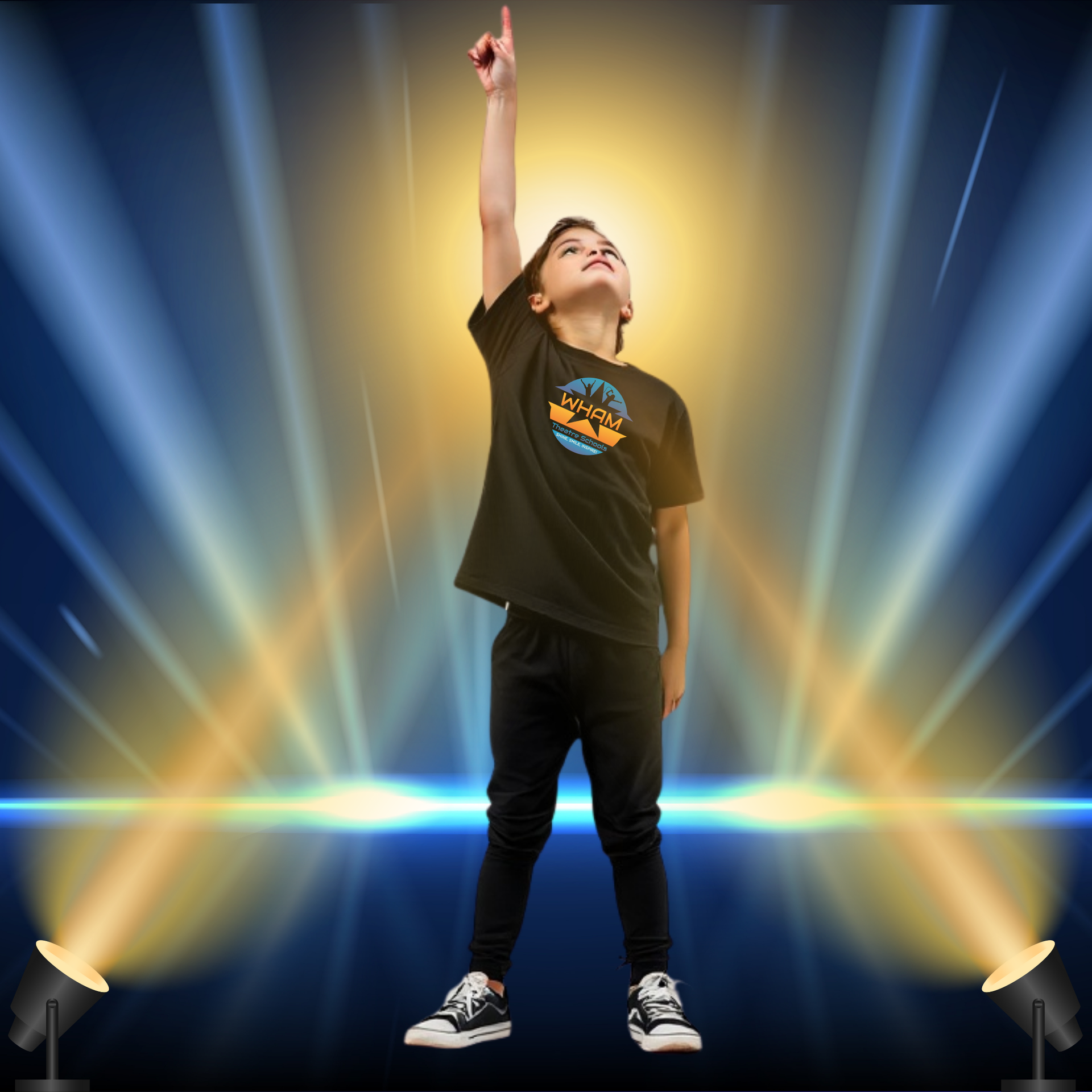 A young boy is standing in front of a spotlight and pointing up