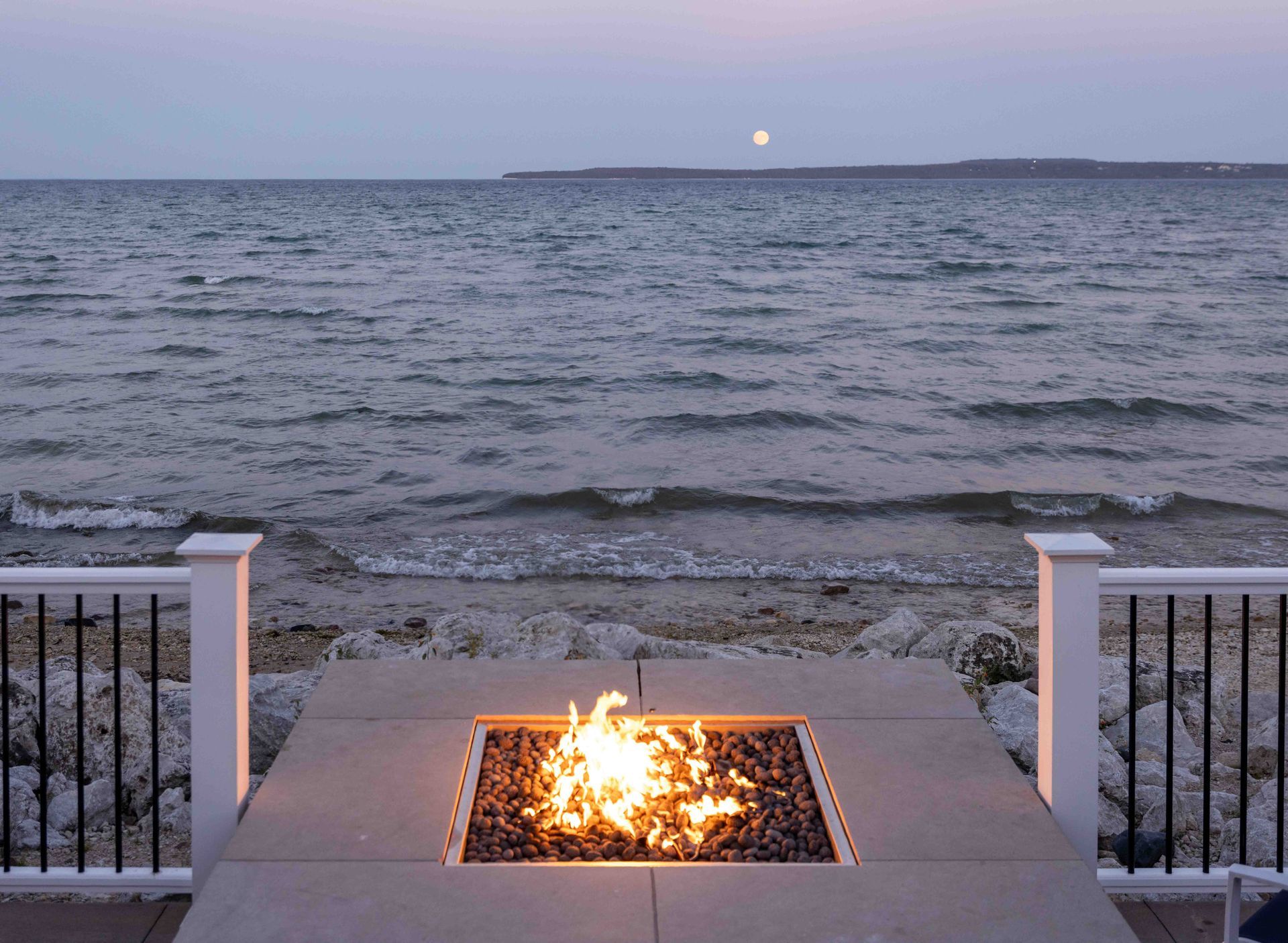 A fire pit with a view of the ocean