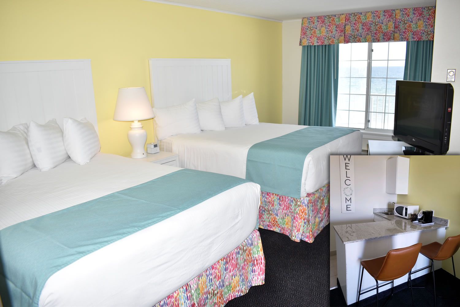 A hotel room with two beds and a flat screen tv