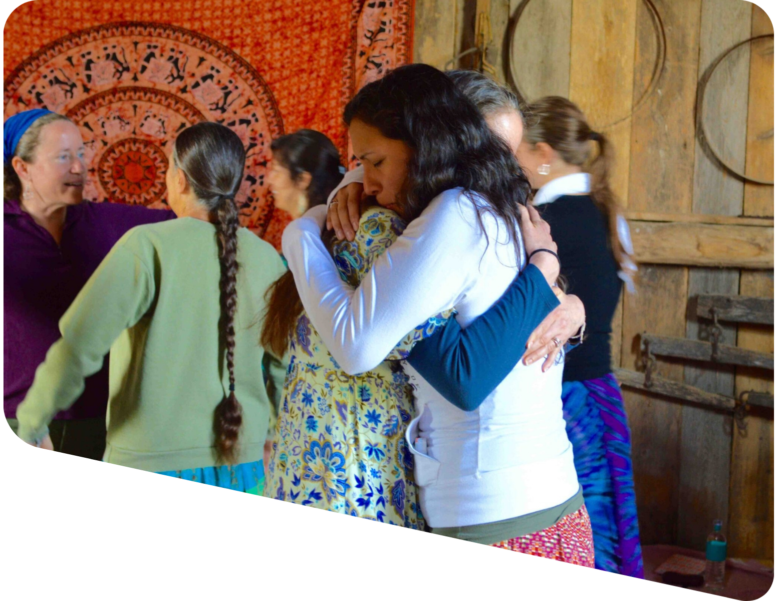 A group of women hugging each other in a room