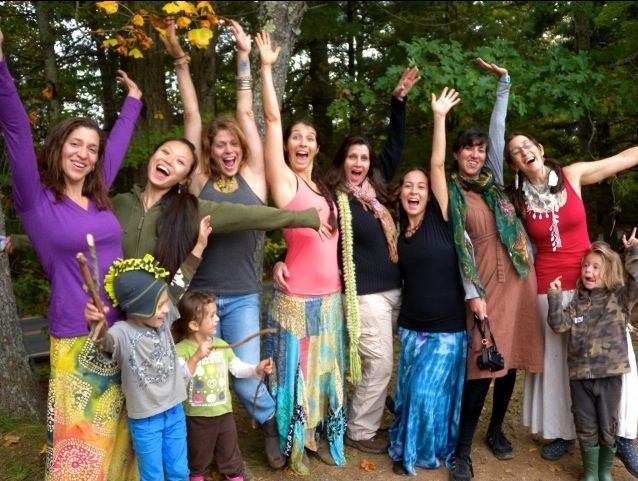 A group of people are posing for a picture with their arms in the air