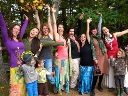 A group of people are posing for a picture with their arms in the air