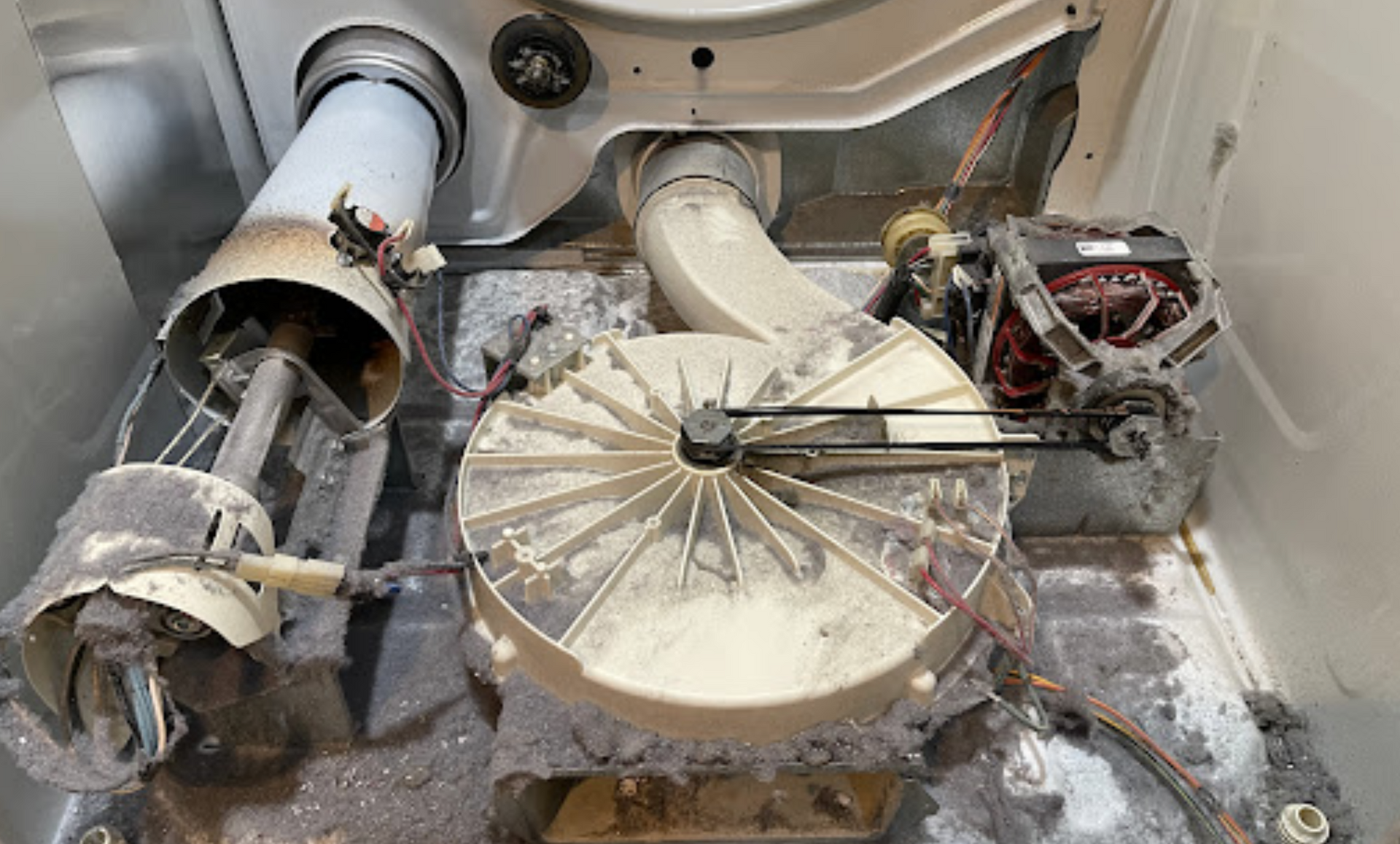 The inside of a dirty washer and dryer is shown.