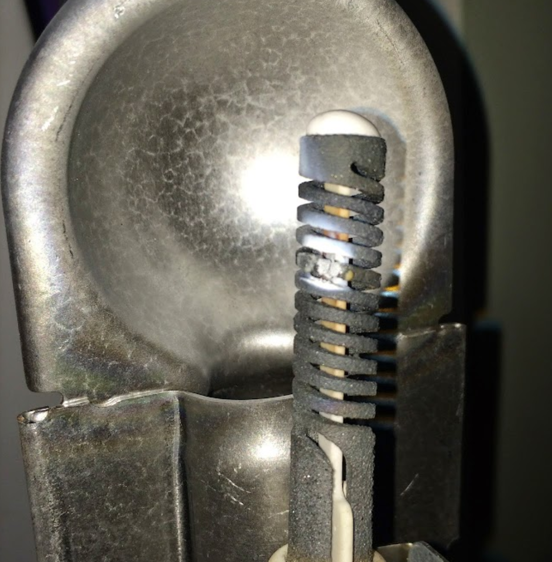 A close up of a metal object with a rubber handle