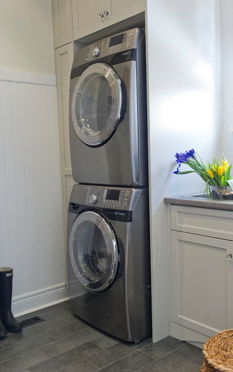 A washer and dryer are stacked on top of each other in a laundry room.