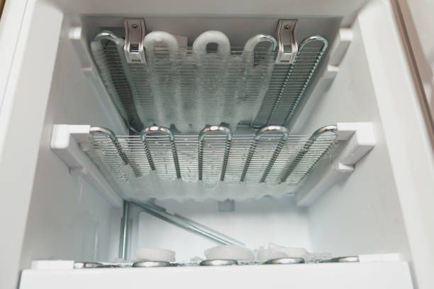 The inside of a refrigerator with ice cubes in it.