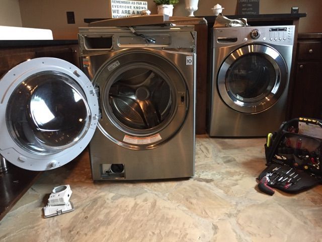 A washer and dryer are sitting next to each other in a laundry room.