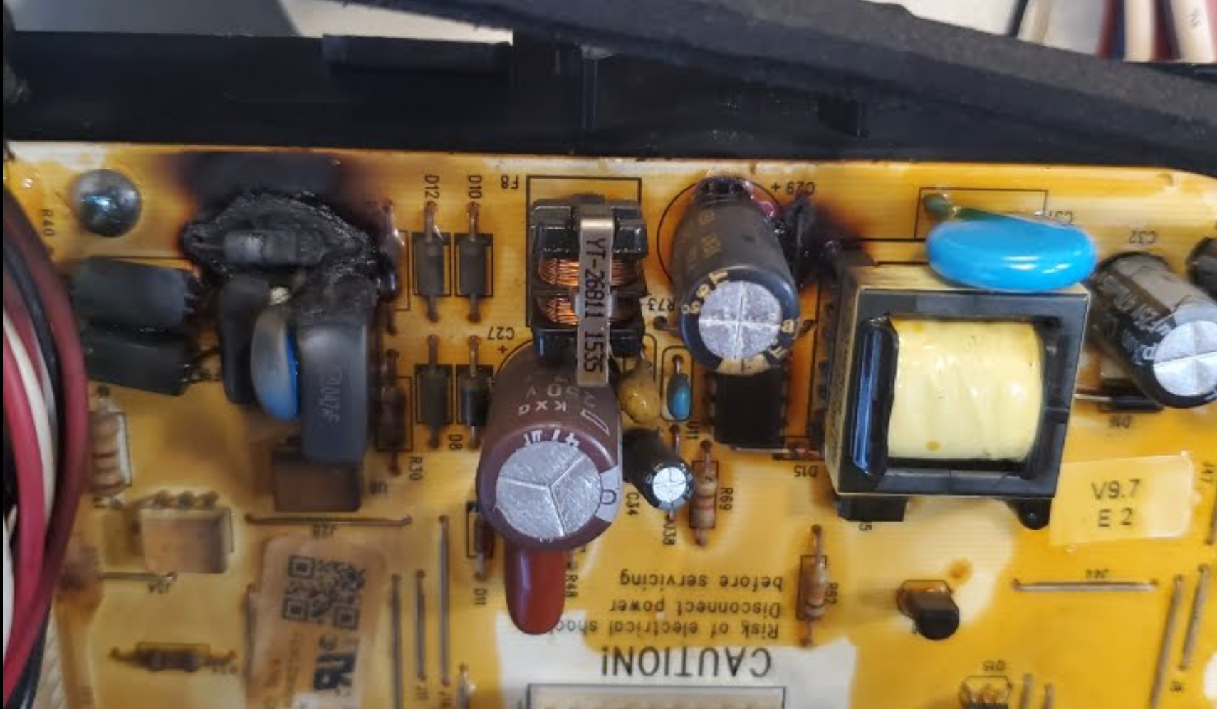 A close up of a circuit board with a caution sign on it