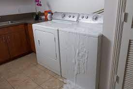 A laundry room with a washer and dryer covered in foam.