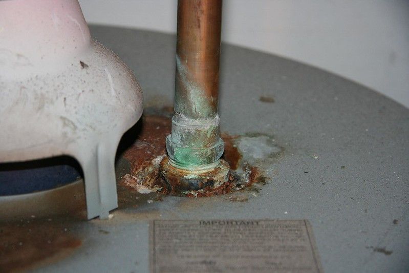A close up of a copper pipe on a water heater.