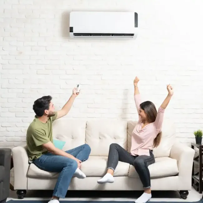 HVAC technician using gauges on an air conditioning unit for maintenance. Close-up on machinery.