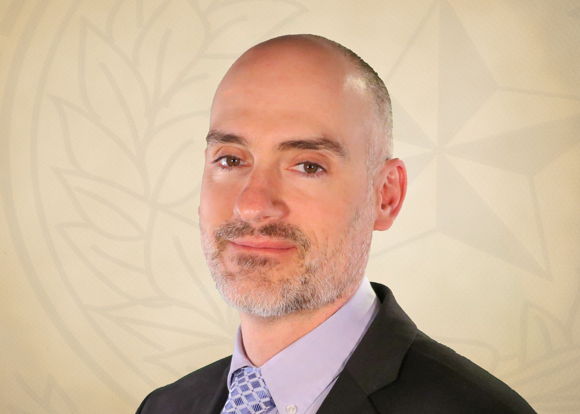 Man in suit smiling, light skin, bald head, looking at the viewer. Background has a star.