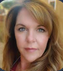 Woman with fair skin and light brown hair looking at the camera.