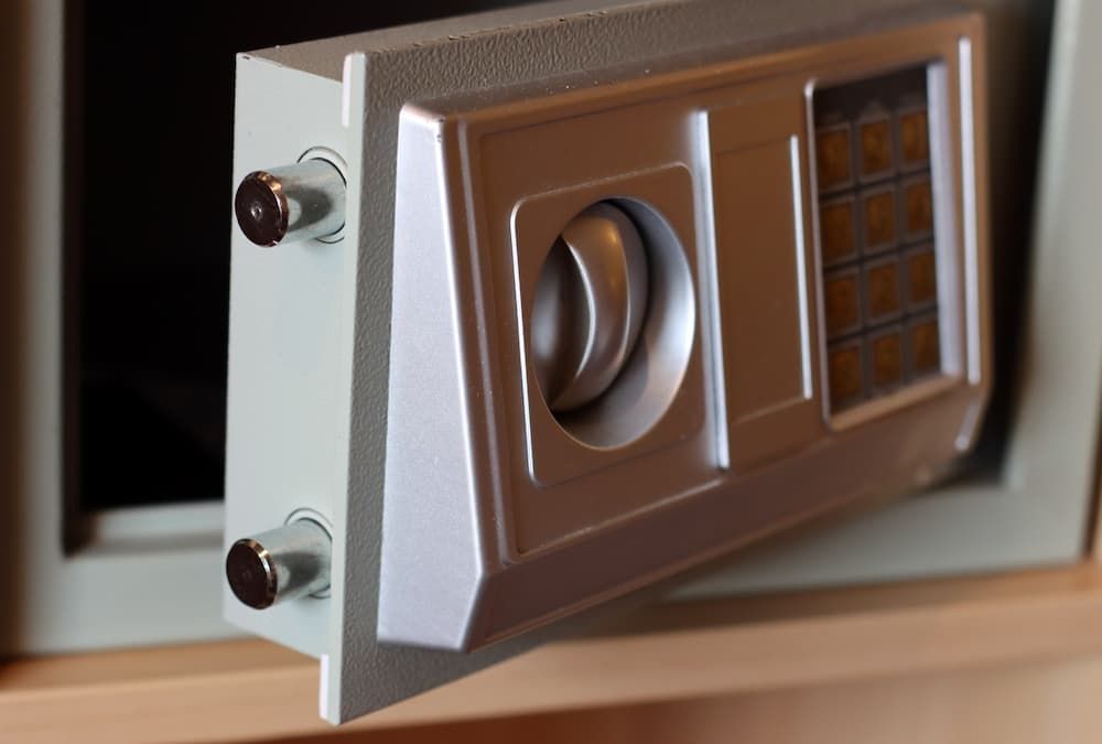 Open digital home safe showing the electronic keypad and locking bolts, emphasizing the need for bat