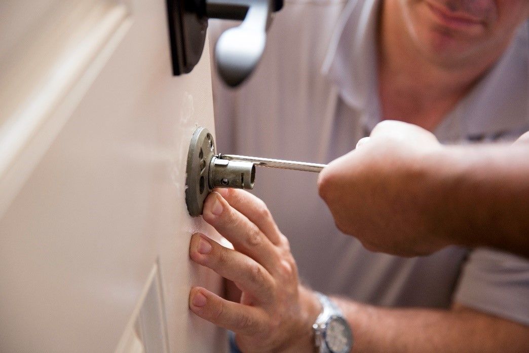 Man fixing door knob
