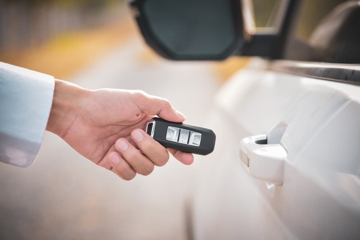 Automotive locksmith services showing a technician programming a new keyless entry remote fob for a 