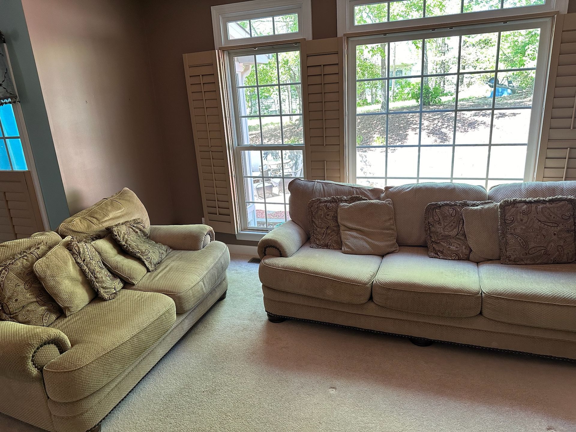 A living room with two couches and a large window