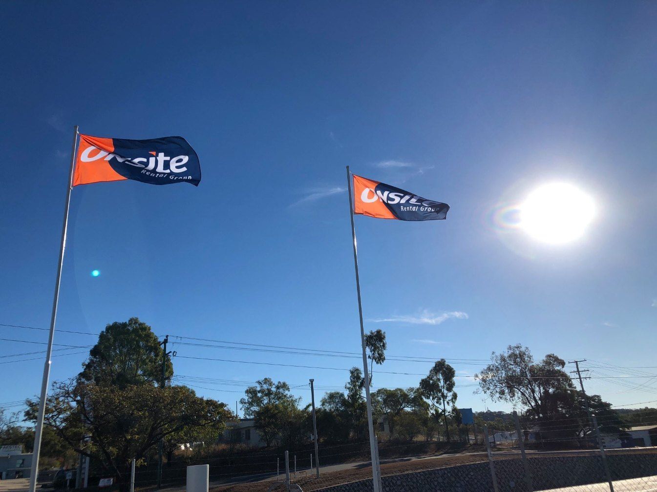 Two Flags With the Word Unsite on Them Are Flying in the Wind — Signtek Gladstone in Gladstone Central, QLD