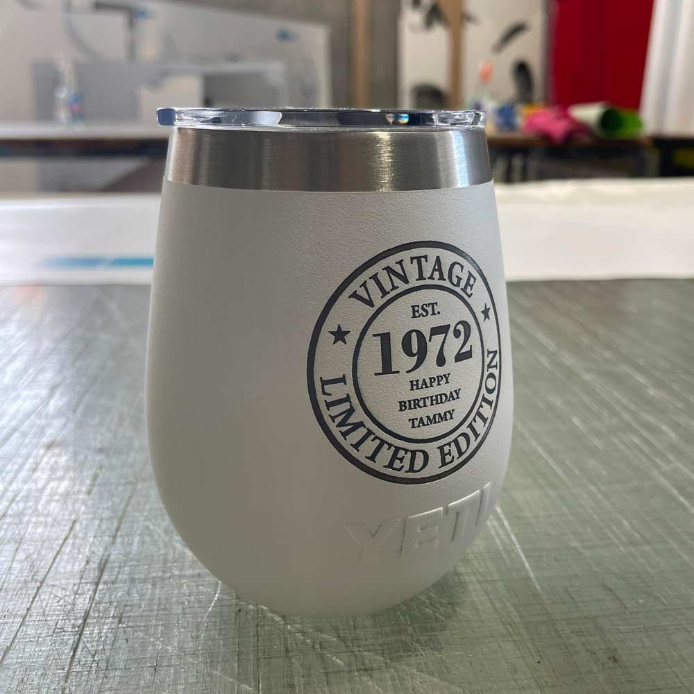 A Vintage 1972 Limited Edition Wine Glass is Sitting on a Table — Signtek Gladstone in Gladstone Central, QLD