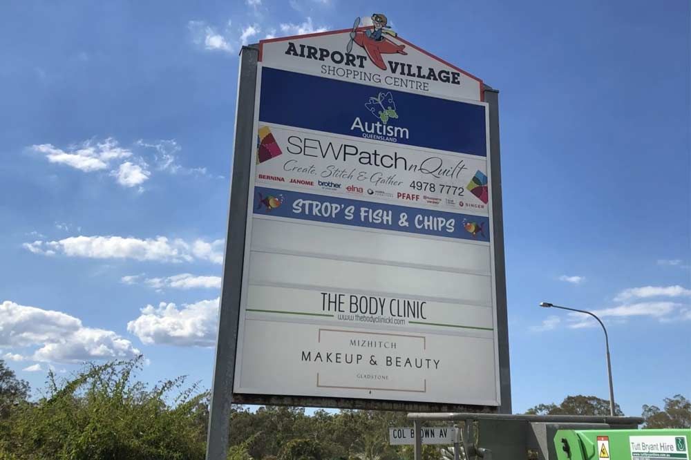 A Sign for Airport Village is Sitting on Top of a Pole — Signtek Gladstone in Gladstone Central, QLD