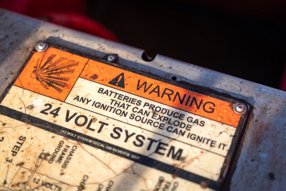 A Close Up of a Warning Sign on a 24 Volt System — Signtek Gladstone in Gladstone Central, QLD