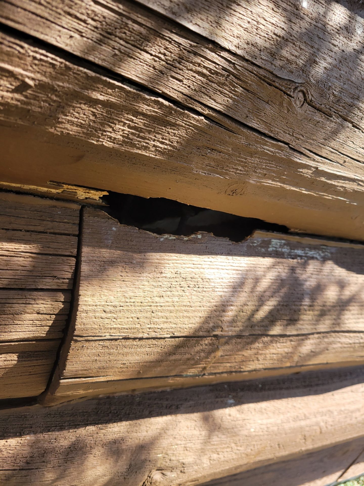 A close up of a piece of wood with a hole in it.