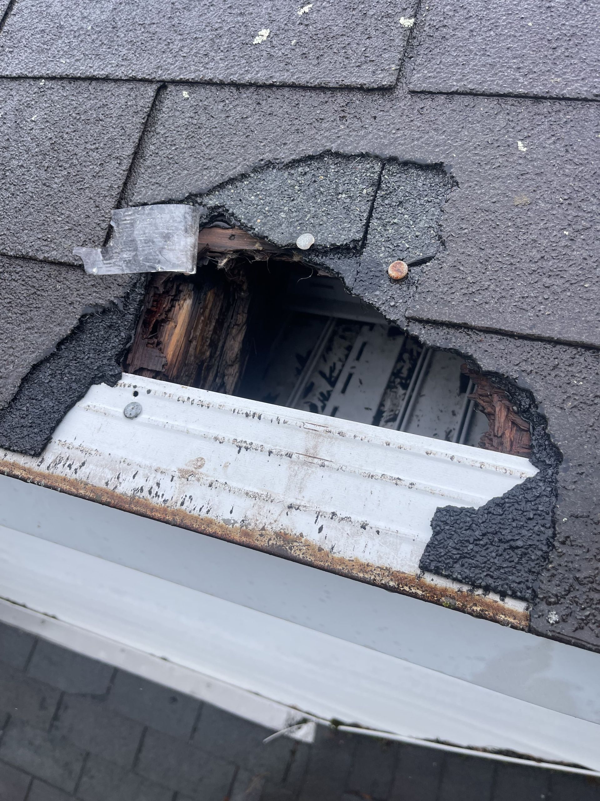 A close up of a roof with a hole in it.