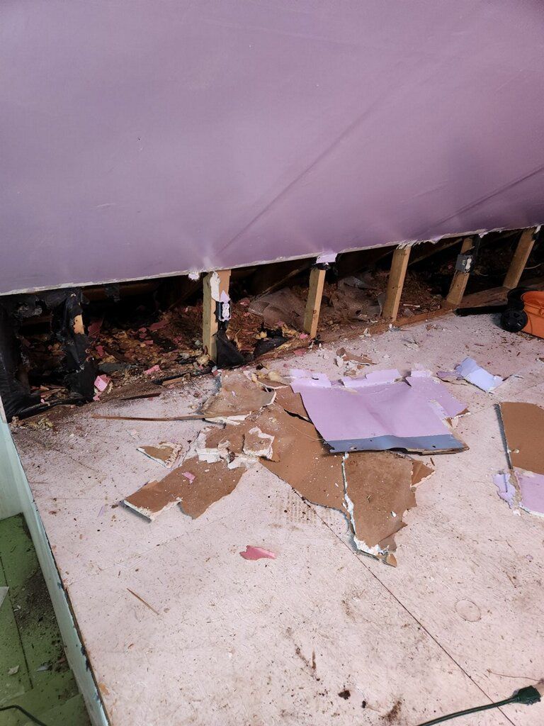 A room with a purple ceiling and a lot of pieces of cardboard on the floor.