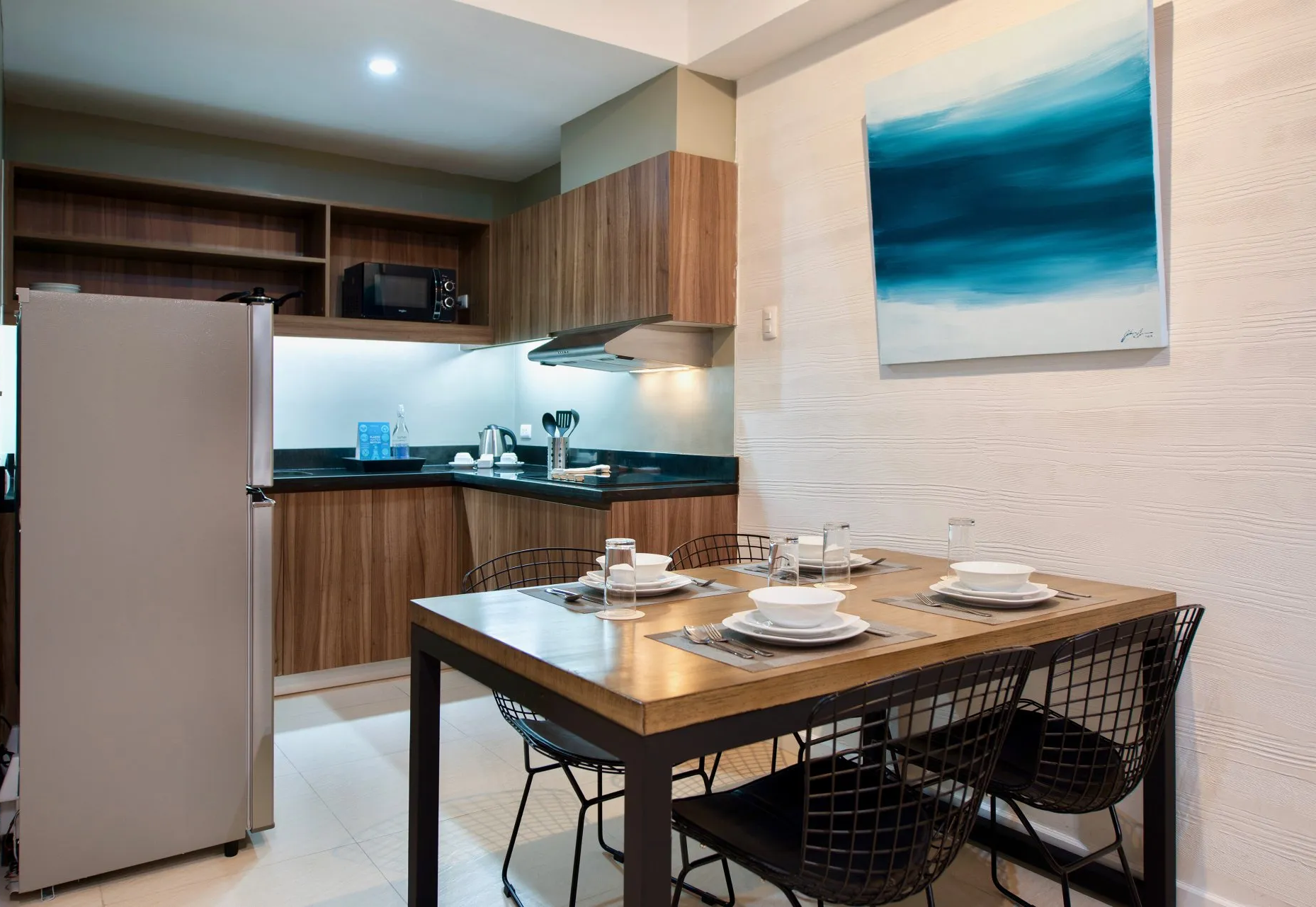 Kitchen and dining area with a table set for four.