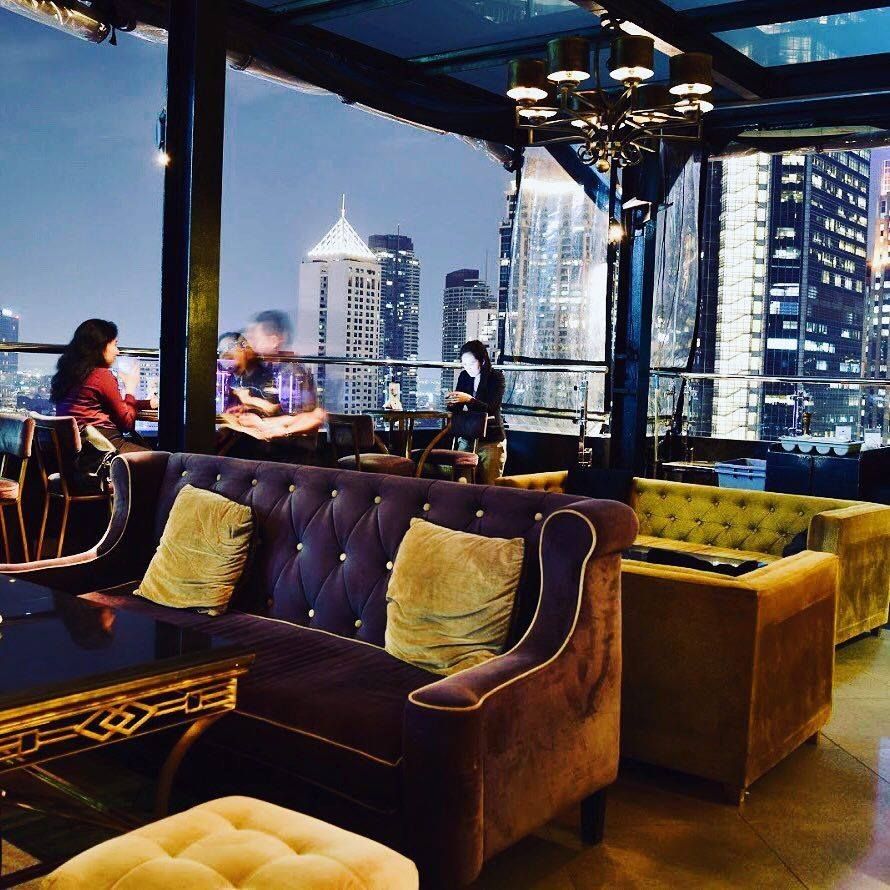 A restaurant with a view of the city at night near The Sphere Serviced Residence